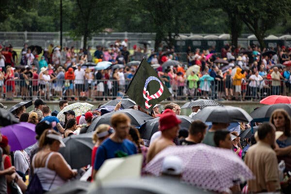 A QAnon flag appeared in a crowd on the National Mall for a July 4 celebration in 2019.