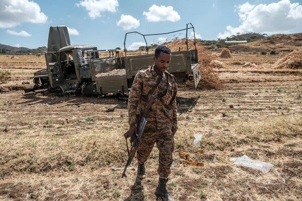 An Ethiopian soldier near a military truck that was destroyed in fighting in the Tigray region in December.