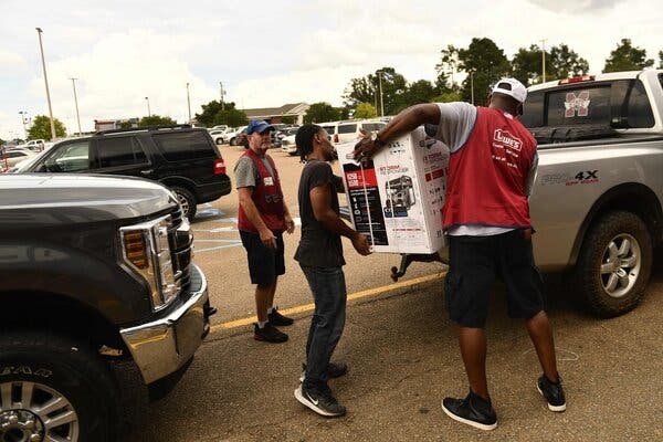 Lowe’s employees loaded a generator onto a truck in McComb, Miss., before Hurricane Ida’s arrival.