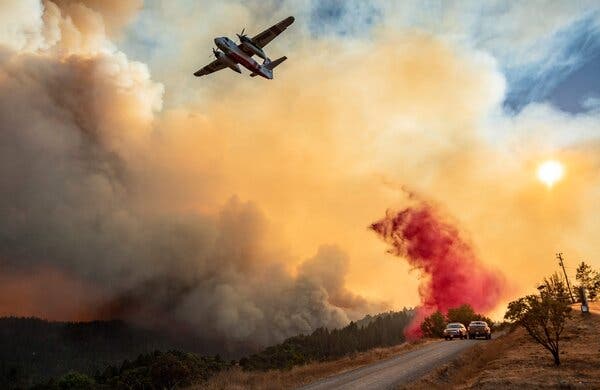 An aircraft drops fire retardant on a ridge during the Walbridge fire in Healdsburg, Calif., last year. Google said it will no longer allow ads that promote climate change denial.