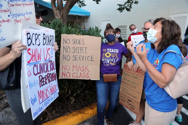 Teachers speaking with anti-mask protesters outside a Broward County School Board meeting in Fort Lauderdale, Fla., last week.