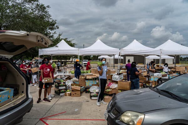 A drive-through food distribution site in Houston. The U.S. labor market continues to lurch through the pandemic with weekly jobless claims hovering around a million.