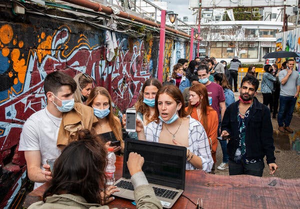 Israelis showing the green passport before entering a concert in Tel Aviv in March. Because of the Delta variant, Israel is bringing back the indoor mask mandate.