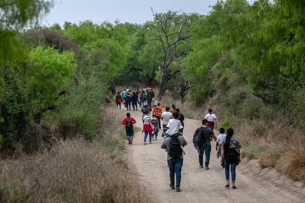 Asylum seekers walking toward a Border Patrol checkpoint in March. Under a Trump-era public health rule, border agents are allowed to rapidly turn away most migrants who have arrived at the southern border during the pandemic.