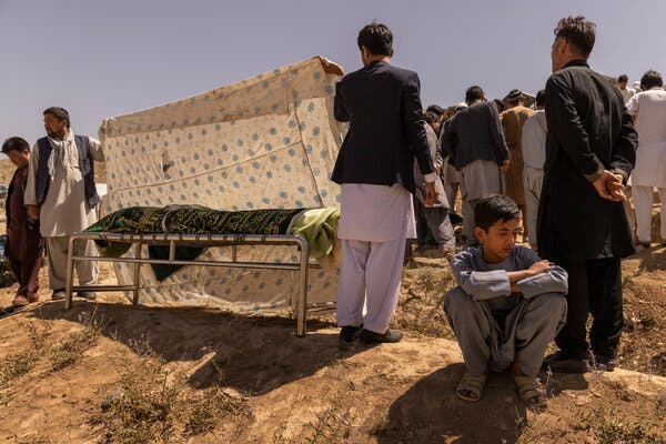 Ruhullah, 16, mourned as family and friends of his father, Hussein, a victim of the suicide attack near Kabul’s airport, buried him in the hills outside the Afghan capital on Friday.