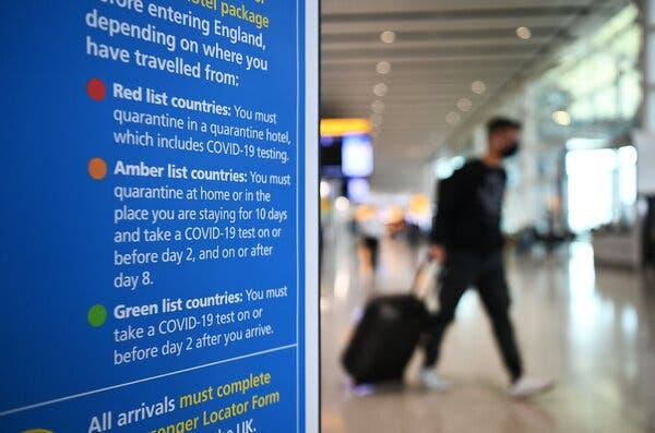 A sign posted in London’s Heathrow Airport. Visitors from the United States, an amber list country, must quarantine for 10 days. But Britain is allowing an exemption for executives of companies with over 500 employees.